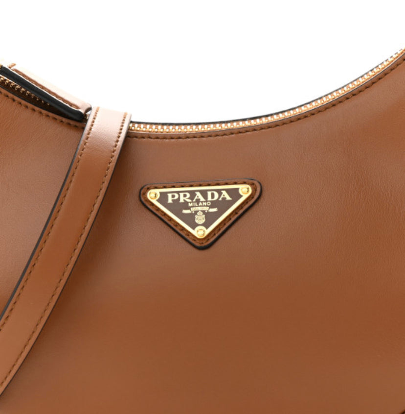 PRADA 
Soft Calfskin Arque Shoulder Bag Cognac