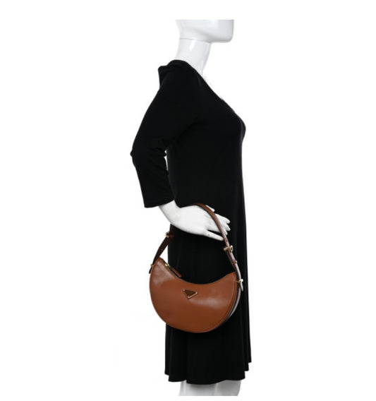PRADA 
Soft Calfskin Arque Shoulder Bag Cognac